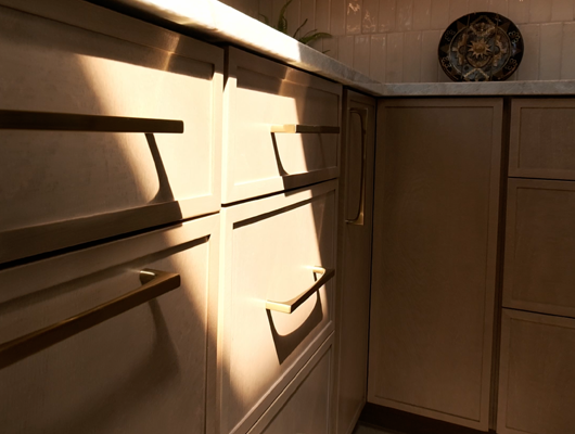 light pouring on custom kitchen cabinets in a custom home in Port Jefferson, NY