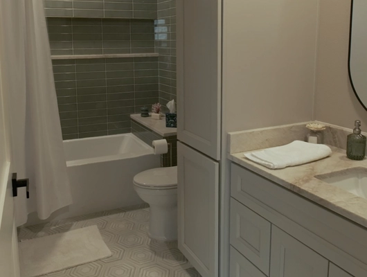 remodeled bathroom with gray cabinets