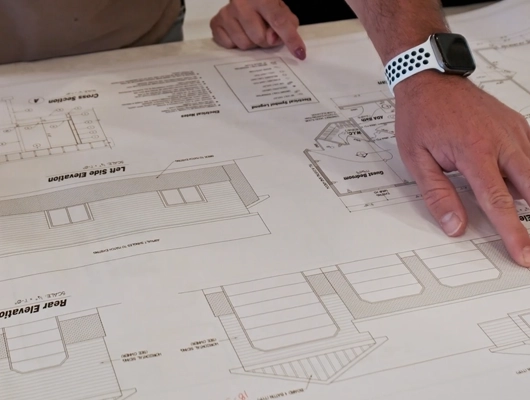 Custom home builder looking over plans