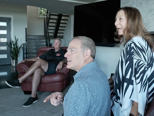 side view of three people sitting in a remodeled home in Port Jefferson, NY