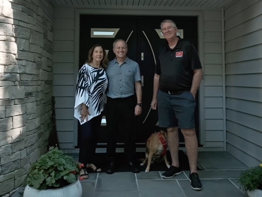 custom home builder and clients standing on the front porch