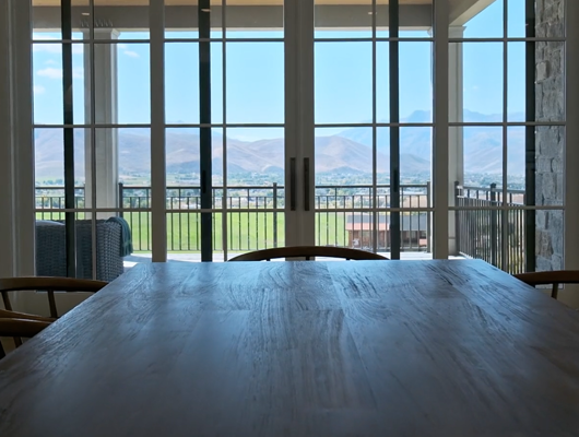 dining room table overlooking deck in a custom built home in Utah county, Utah