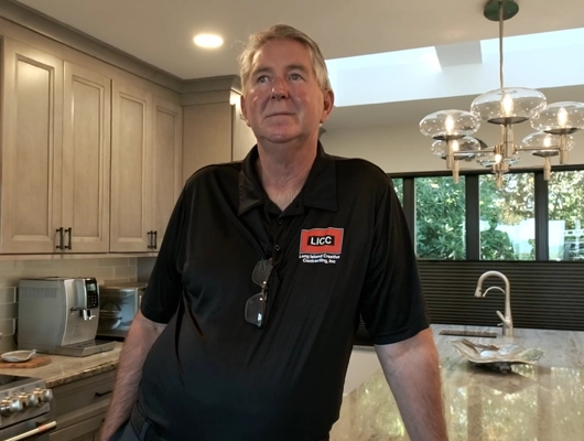 John Petsco standing inside a remodeled home in Port Jefferson, NY