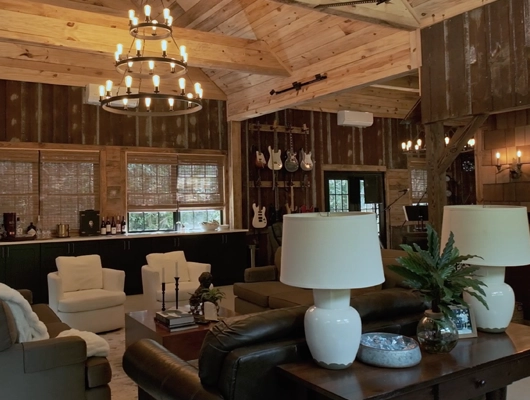 sitting area with a chandelier inside a barn