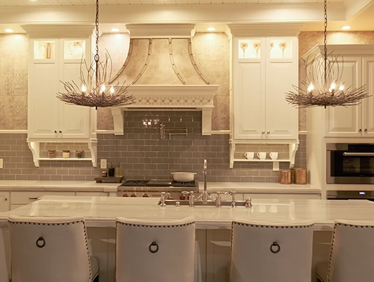 white kitchen with island and pendant lights