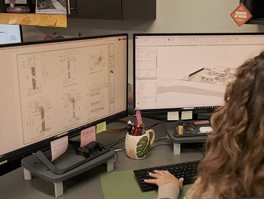 woman architect viewing plans on computer
