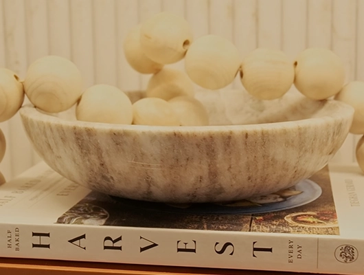 detail shot of wooden beads in a stone bowl