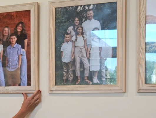 custom home builder fixing a picture on the wall