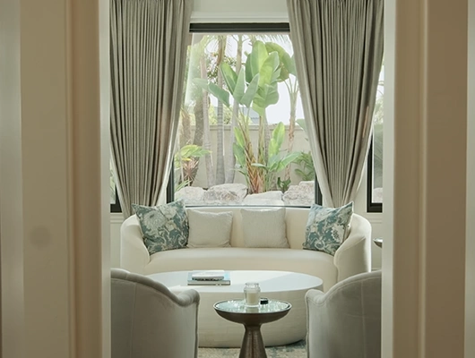 white semi circle couch with oriental patterned pillows