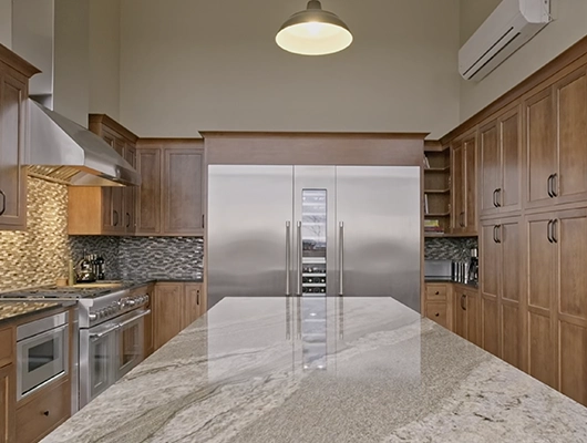 kitchen with large island anddouble fridge with wine cooler